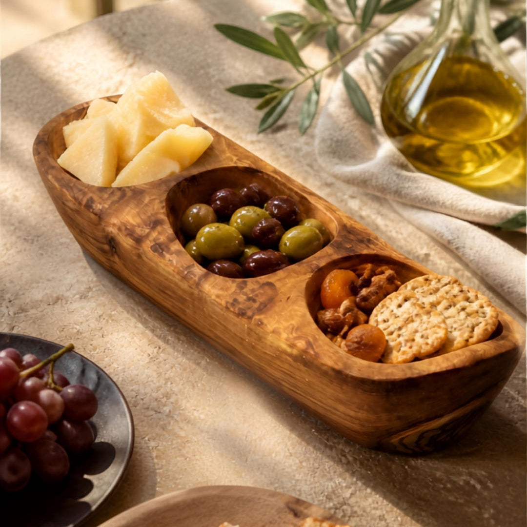 Olive wood serving tray with cheese, olives and crackers