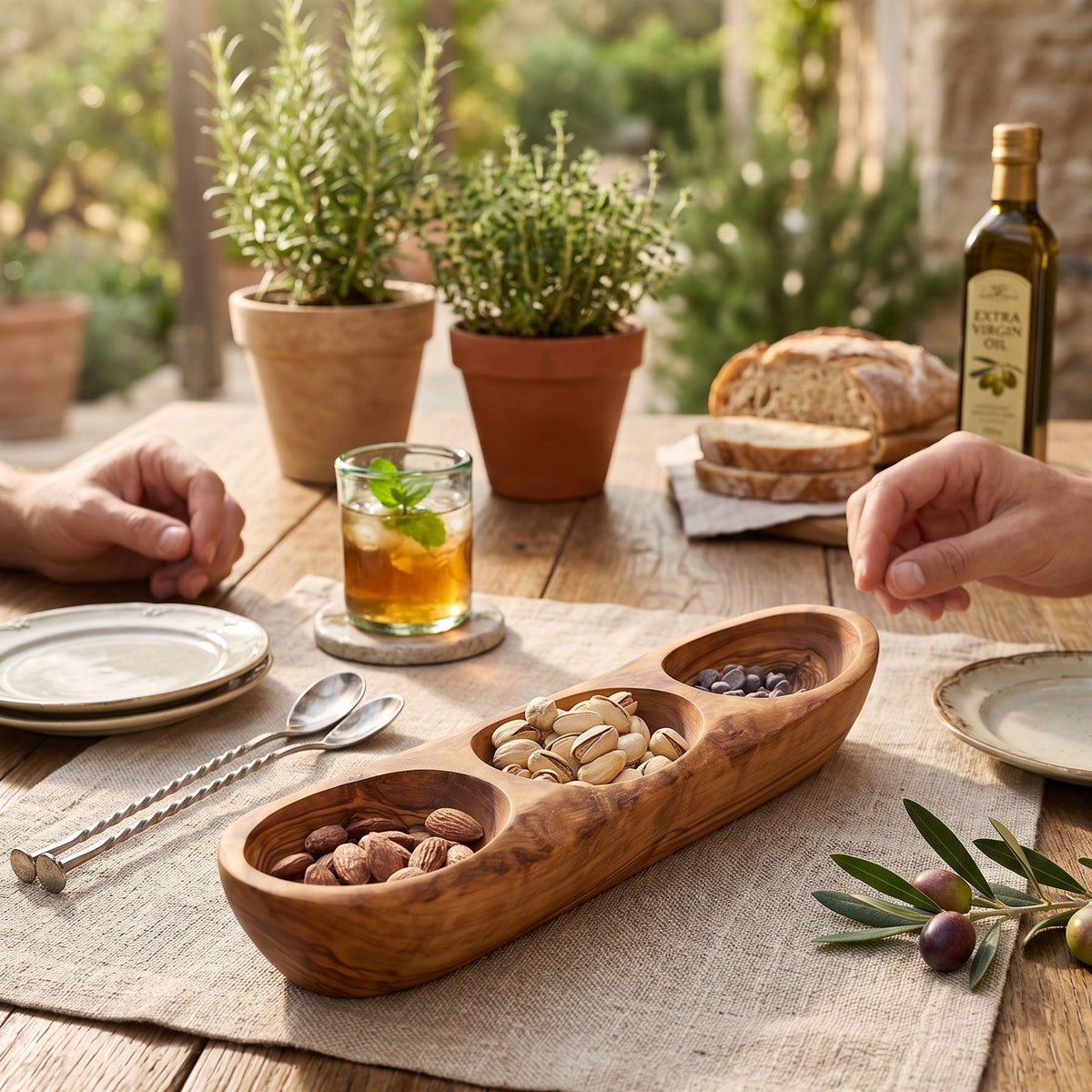 Olive wood serving tray with nuts on an outdoor table