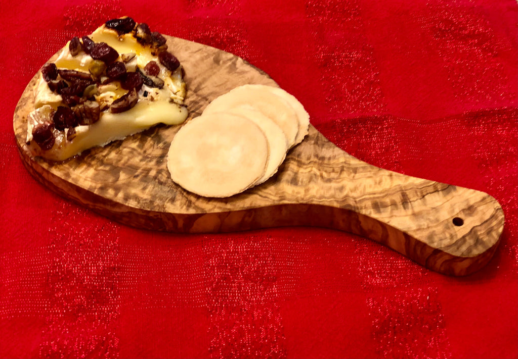 Olive wood board serving cheese and crackers